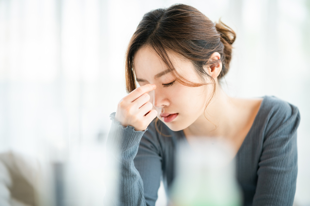 体調不良の女性