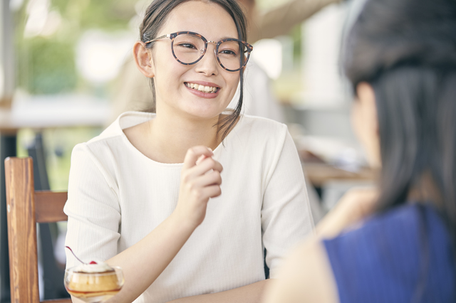 笑顔で友達と会話する女性